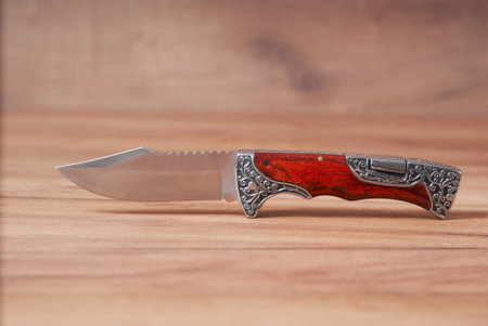 Hunting knife on a wooden background made of high quality stainless steel.の写真素材
