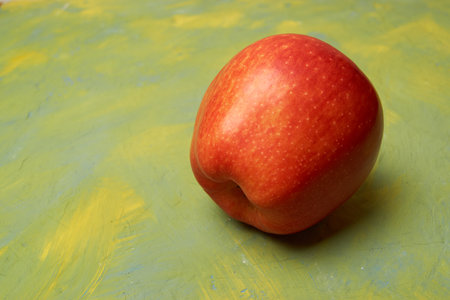 Fresh isolated red apple on a yellow green background. Empty space for the text.の写真素材