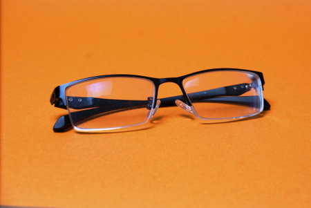 Close-up glasses on a bright orange background