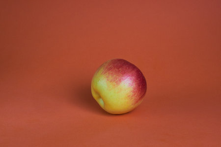 Red -yellow fresh apple on a brown backgroundの写真素材