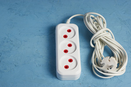 electric extension cord on a blue backgroundの写真素材