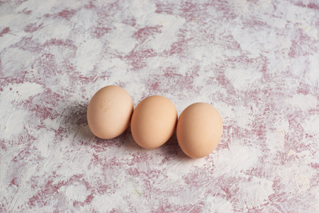 Three Easter brown eggs on a light background