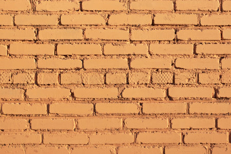 brick wall painted with yellow texture of yellow brick wallの写真素材