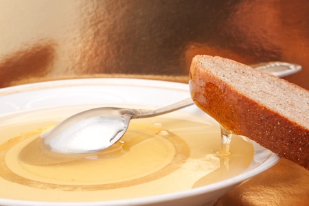 The still life with the natural honey and slice of brown breadの写真素材