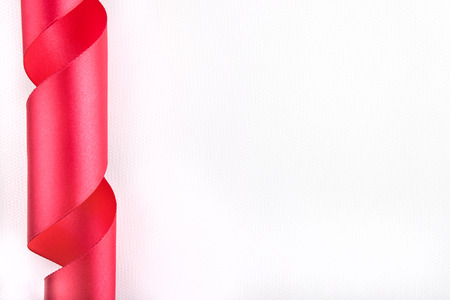 Simple background with the red twisted ribbonの写真素材