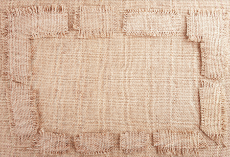 Burlap Background with Frame from Fringed Patchesの写真素材