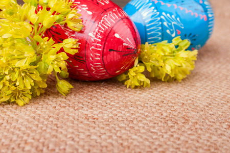 Spring Yellow Flowers and the Easter Eggs on the Burlap