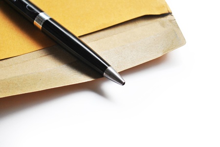 The envelope and pen are on the white backgroundの写真素材