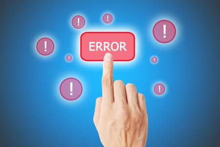 The hand is pressing the error buttonの写真素材