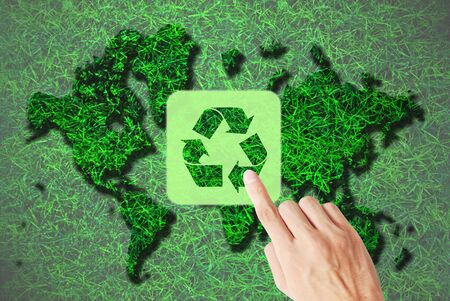 Hand press recycle symbol is on the mapの写真素材
