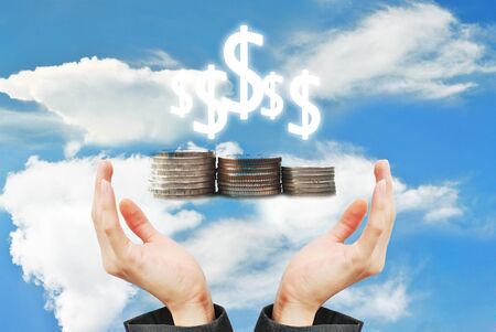 People hold the coins in the hand on skyの写真素材