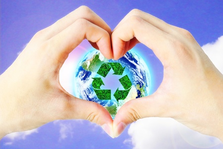 The hand heart and recycle sign is on the sky background