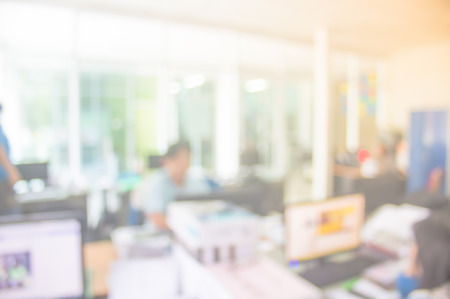 Businessmen blur in the workplace.Table Top And Blur Office of Background.abstract blur background table work in office with computer.Abstract background of office, shallow depth of focus.の写真素材