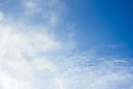 white fluffy clouds in the blue sky abstract background.の写真素材