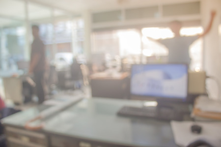 Businessmen blur in the workplace.Table Top And Blur Office of Background.abstract blur background table work in office with computer.Abstract background of office, shallow depth of focus.の写真素材