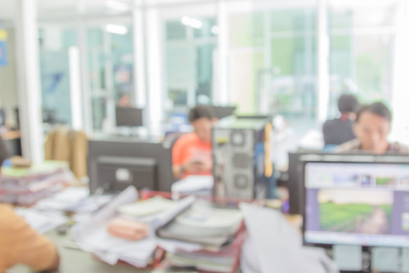 Businessmen blur in the workplace.Table Top And Blur Office of Background.abstract blur background table work in office with computer.Abstract background of office, shallow depth of focus.の写真素材
