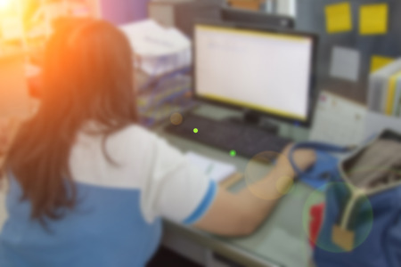 Businessmen blur in the workplace or work space of table work in office with computer or shallow depth of focus of abstract background.の写真素材