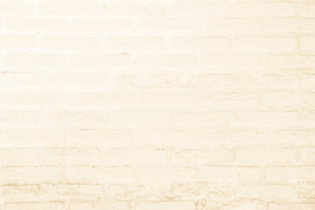 Cream and white brick wall texture background. Brickwork or stonework flooring interior rock old...