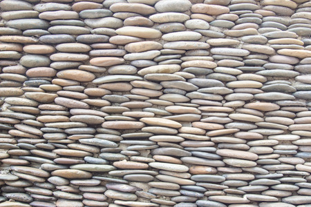 Gravel wall round stone rock texture and seamless backgroundの写真素材