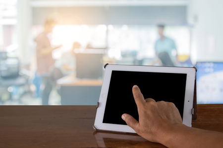 Businessmen hands touching digital tablet with business diagram on table blur in the workplace....