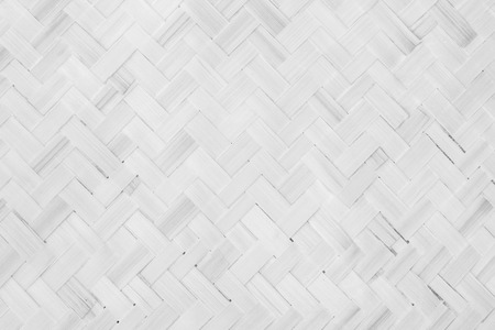Gray Mat Traditional handicraft bamboo weave texture background. Wicker surface pattern material for wall with antique cracking furniture painted weathered white vintage peeling wallpaper or board.の写真素材