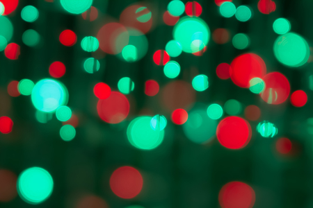 Christmas lights bokeh on transparent background. Xmas glowing garland. Blurred colorful light, violet, red, green, white in soft fading tone. Abstract impressive distress wallpaper.の写真素材