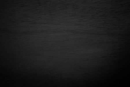 Abstract vignette black wood texture high quality close up. Dark furniture plank material wallpaper. Blank grunge wooden grain surface be used design as background or board luxury floor copy space.の写真素材