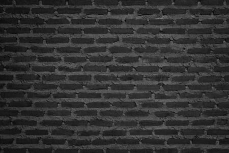 Wall dark brick wall texture background. Brickwork or stonework flooring interior rock old pattern clean concrete grid uneven bricks design stack. Copy space with construction.の写真素材