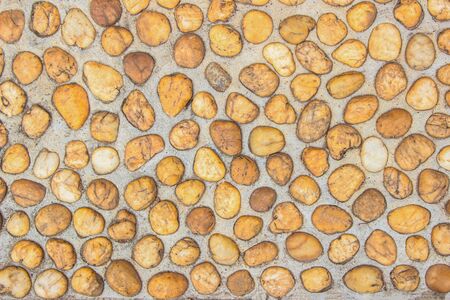 Floor gravel pebble stone on concrete wall background or fence texture made of a close up of...