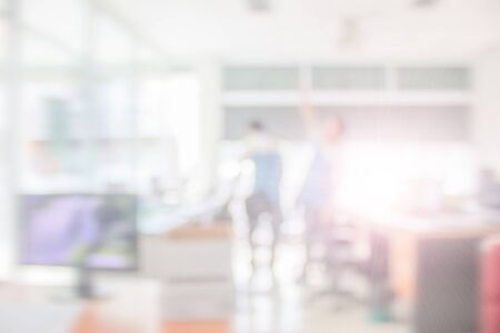 Businessman blur in the workplace at sitting on a computer screen work space on table desk work in office blurry, document division and people shallow depth of focus horizontal abstract interior.の写真素材