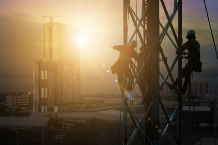 silhouette workers on background of construction crews to work on high ground heavy industry and...