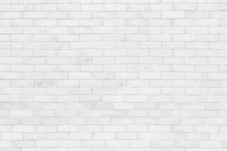 White brick wall texture background in room at subway. Brickwork stonework interior, rock old concrete grid uneven abstract weathered grey clean tile design, horizontal architecture wallpaper.の写真素材