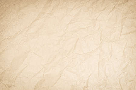 Brown or Cream recycled craft paper texture background. Pattern rough creased old vintage page for surface design. Cardboard with copy space for text letter. Backdrop paperwork product or education.の写真素材