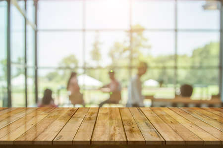 Top table with bokeh light blur restaurant. Wooden empty table in front of blurred background....