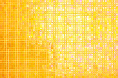 Yellow ceramic wall and floor tile abstract background. Design geometric orange mosaic texture decoration of the bedroom. Simple seamless pattern grid for backdrop hospital wall, canteen and kitchen.の写真素材