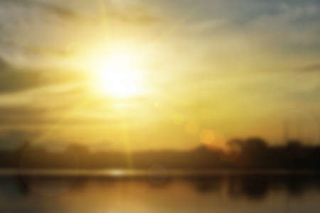 Relaxing outdoors vacation landscape concept: Abstract blurred sunlight beach colorful blurred bokeh background with retro effect autumn sunset sky have blue bright, white, and color orange calm.の写真素材