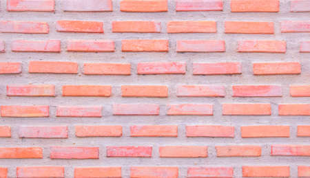 Orange and white brick wall texture background. Brickwork and stonework flooring interior old pattern clean concrete grid uneven bricks. Background old vintage brick wall backdropの写真素材