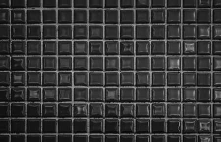 Dark black ceramic wall and floor tiles mosaic background in bathroom and kitchen. Design pattern geometric with grid wallpaper texture decoration pool. Simple seamless abstract surface grunge.の写真素材