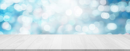 Christmas holiday background with empty wood table over winter bokeh. In the background of xmas...
