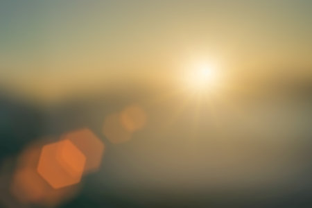 Natural sunlight background blurring, misty waves warm colors bright sun light. Christmas background sky sunny color orange light patterns, abstract flare evening on clouds blur.の写真素材
