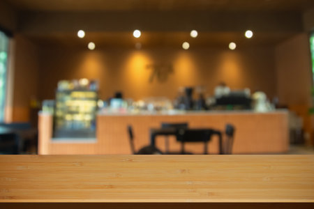 Selected focus empty brown wooden table and Coffee shop blur background with bokeh image, for product display montage.の写真素材