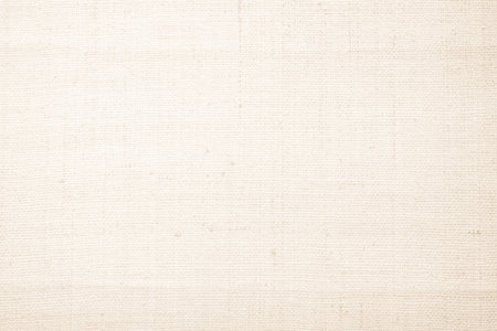 Brown sackcloth woven texture background in natural pattern. Jute hessian burlap, linen background in light beige cream color blank. Weaving canvas fiber line cotton cloth textured as organic.の写真素材