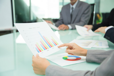 Businessman hold a Sales Volume report