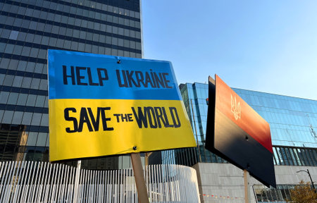 People have a Ukrainian flag on their shoulders in honor of defenfers of Ukraine Vancouver rally Art Gallery Ukrainians took to the streets against Russian terrorism People in embroidered shirtsのeditorial素材