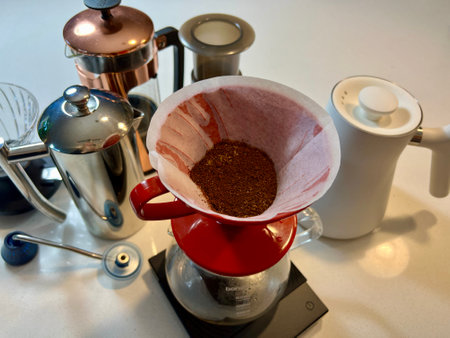 professional coffee shop On white table in kitchen there are different devices for brewing craft coffee Nearby grows a coffee tree Coffee Server, White Kettle, french press, Coffee grinder and pourersのeditorial素材