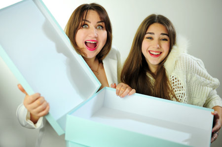Online delivery empty boxes emotions facial expression greetings and gifts Mom and daughter look into box are surprised have fun and rejoice Woman aged 40 girl 16-18 positive emotions beautiful peopleの写真素材