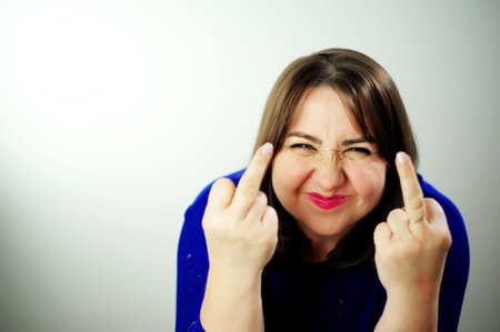 an adult woman shows the middle finger at the camera she shows an obscene gesture go away everyone...