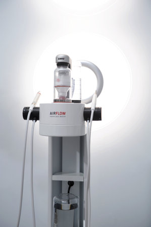 Airflow Device for deep cleaning of teeth from tartar Cleaning stones and plaque The newest apparatus on a white background Dentistry new inventionsのeditorial素材