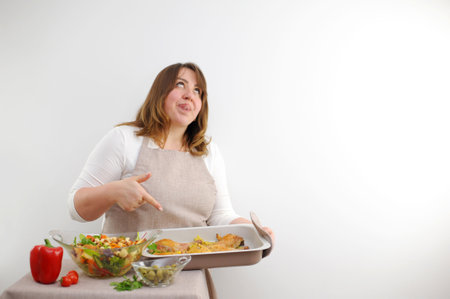 funny facial expression at cook puffy woman rolled eyes stuck tongue out and licks lips with...