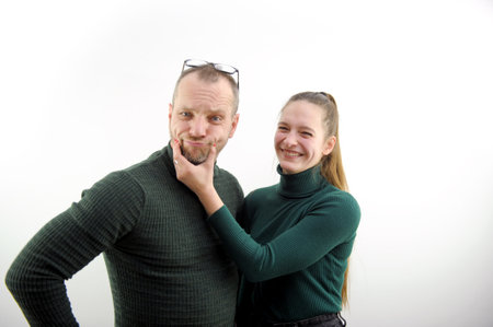 a happy loving couple fooling around and hugging at home in the kitchen. cozy and beautiful clothes for the house. romantic relationships. psychological assistance to young families. Valentines Dayの写真素材